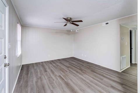 A room with a ceiling fan and light fixture.