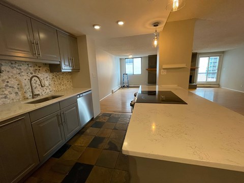 A kitchen with a checkered tile floor and a counter top.