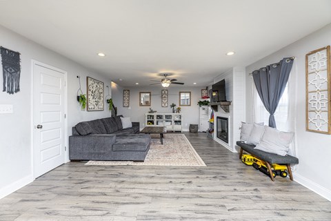 A living room with a grey couch and a white door.