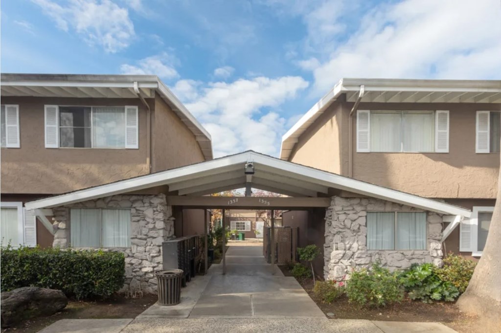A residential area with two houses connected by a bridge.