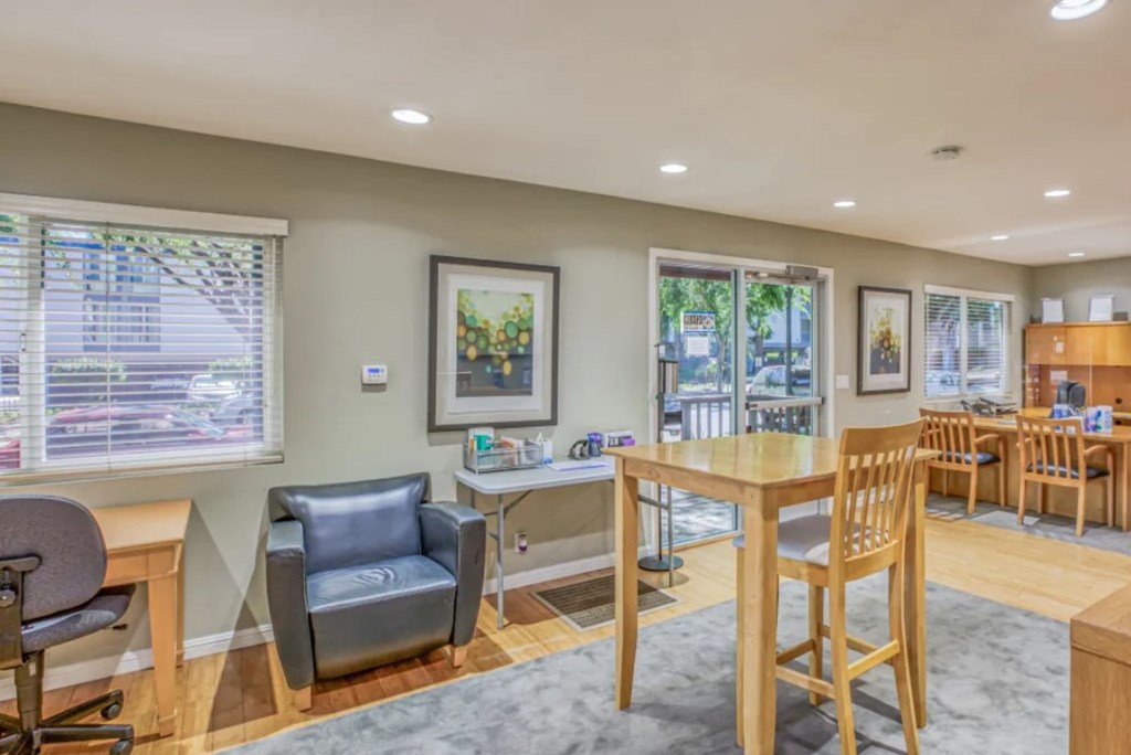 A waiting room with a table and chairs.