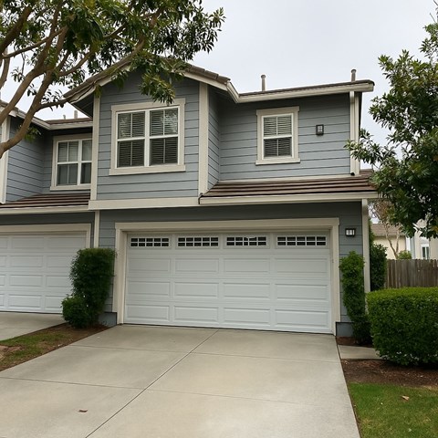A two-car garage is attached to a house.