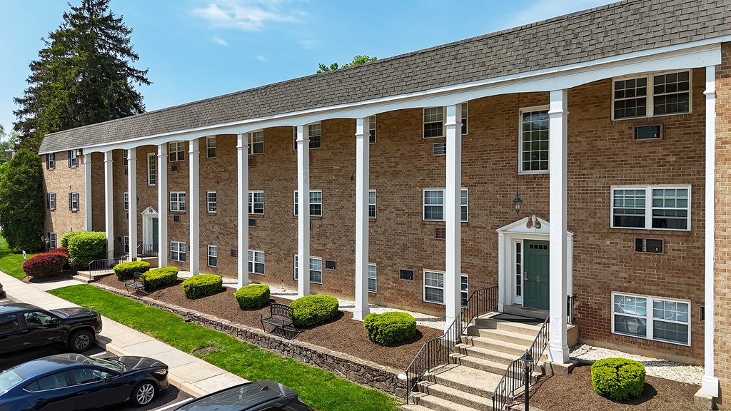 A building with a green lawn in front.