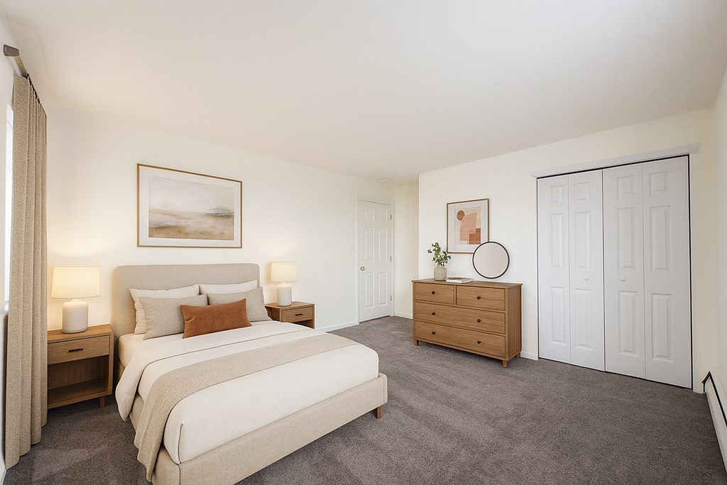 A bedroom with a large bed, nightstands, and a dresser.