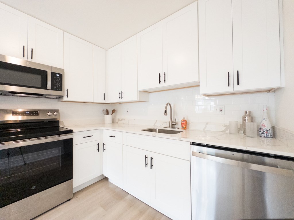 A long brick building with white columns and windows.