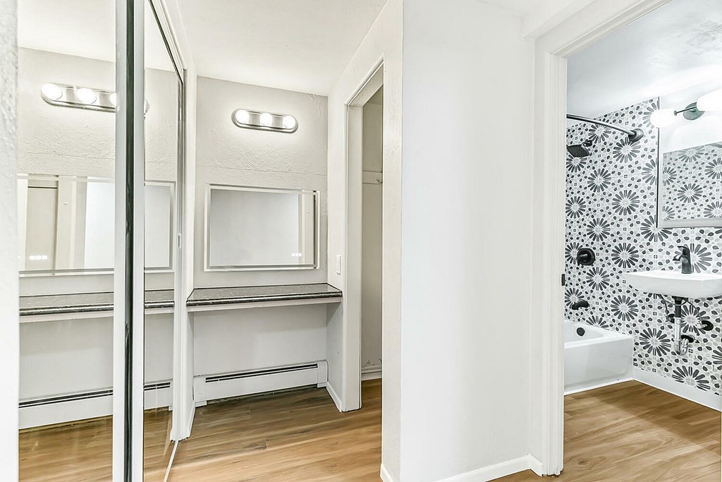 A white bathroom with a shower and a sink.