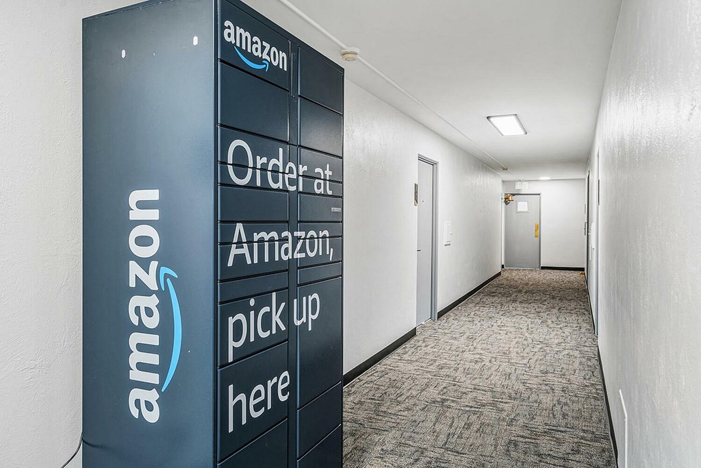 A tall Amazon sign is in a hallway.