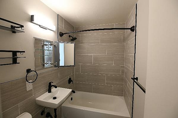 A bathroom with a white sink and a white toilet.