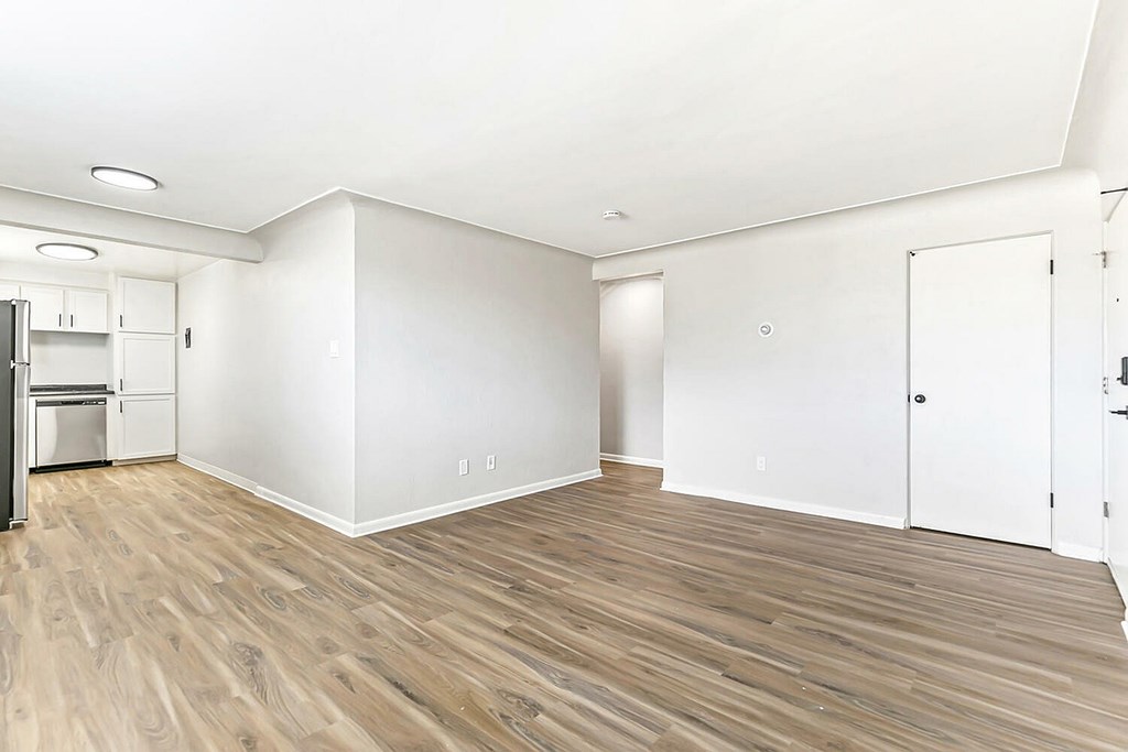 A room with wooden floors and white walls.