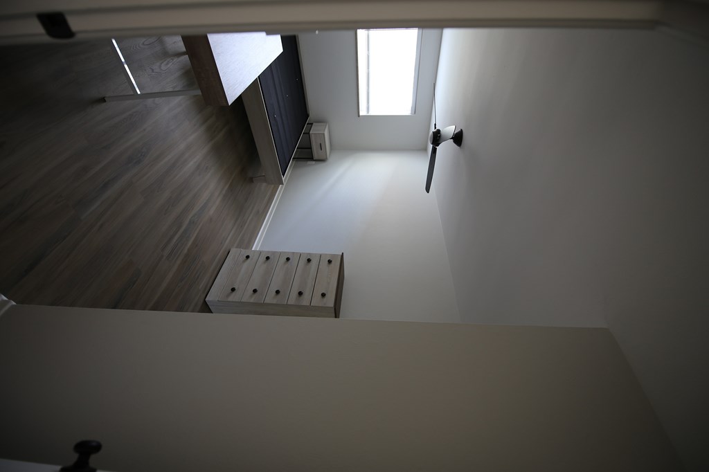 A wooden staircase leading to a window.
