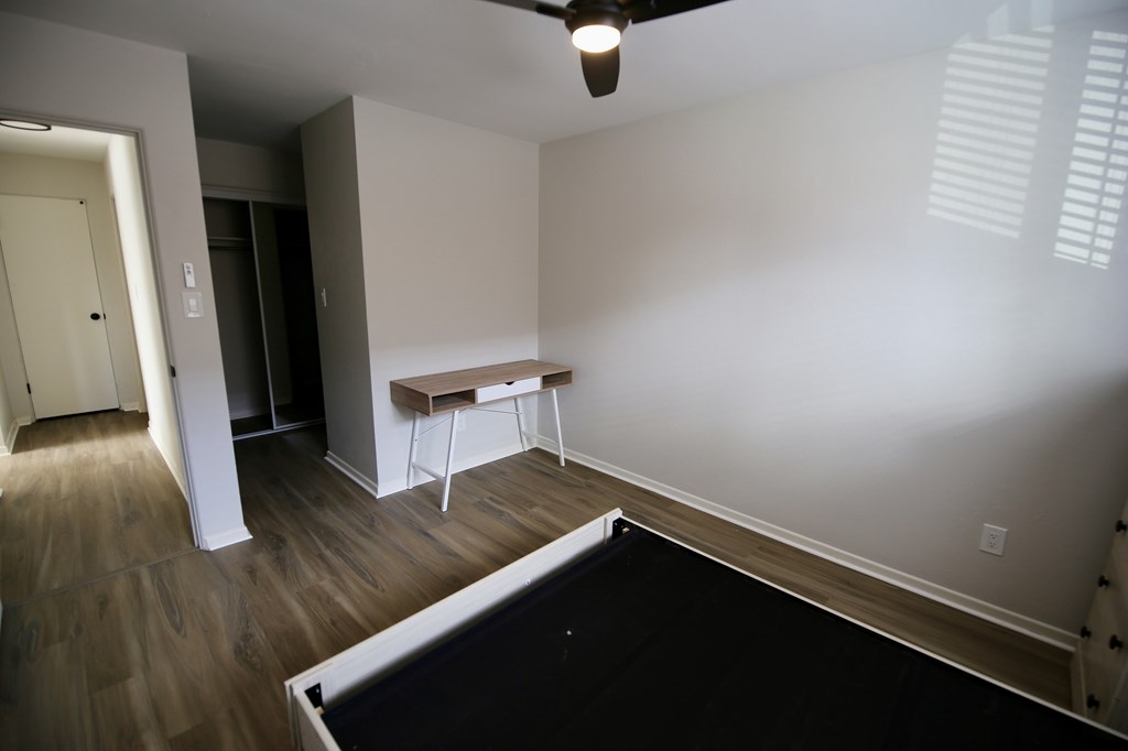 A room with a pool table and a bench.