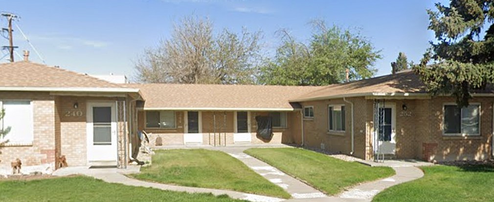 A house with a brown roof and a white door.