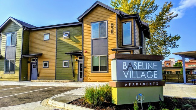 Baseline Village Apartments is a modern apartment complex with a mix of green and yellow exterior colors.