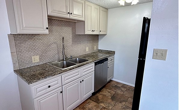 A backyard with a gazebo and a deck.