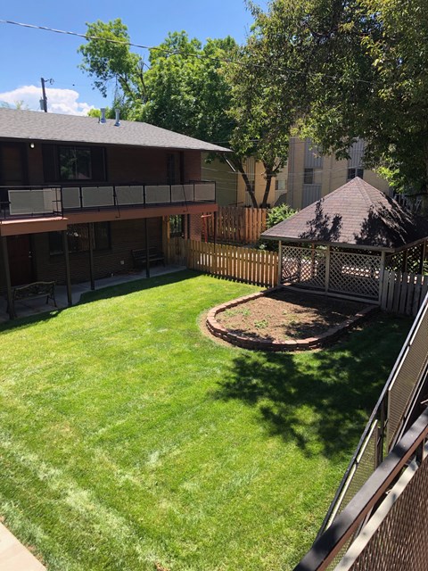 A backyard with a gazebo and a deck.