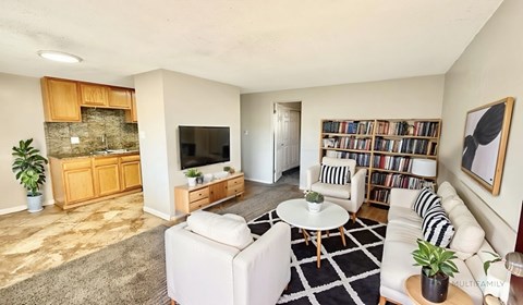 A kitchen with a fan and brown tiles.