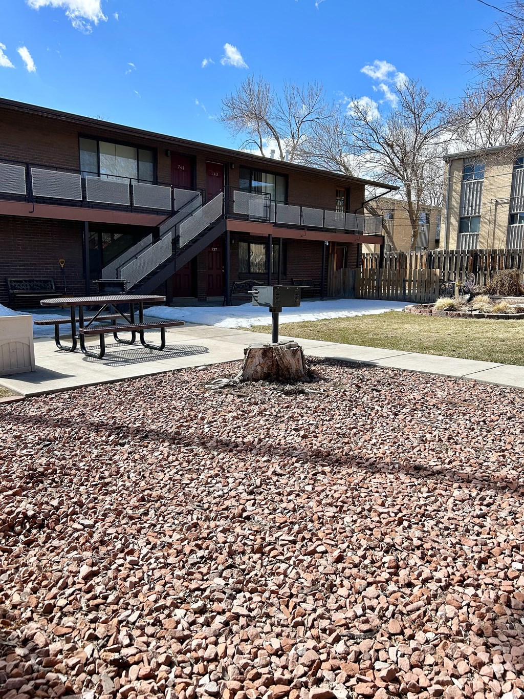 A building with a red door and a staircase outside.