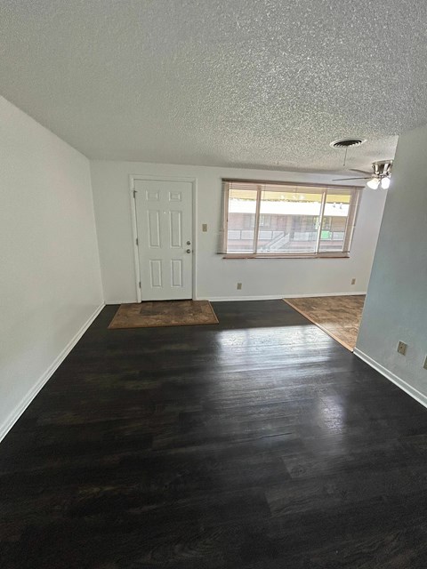 A room with a white door and a window with blinds.