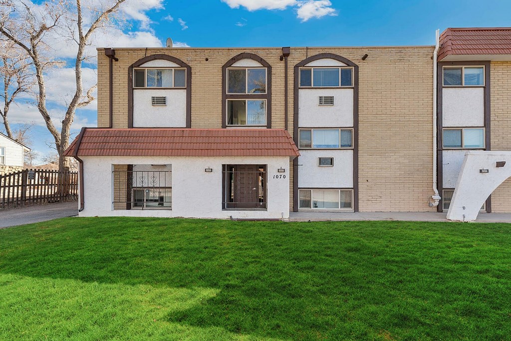 A building with a red roof and white walls with windows.