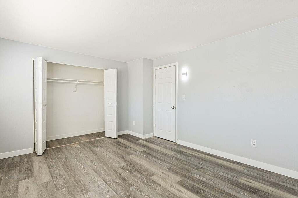 A room with a white door and a white wall.