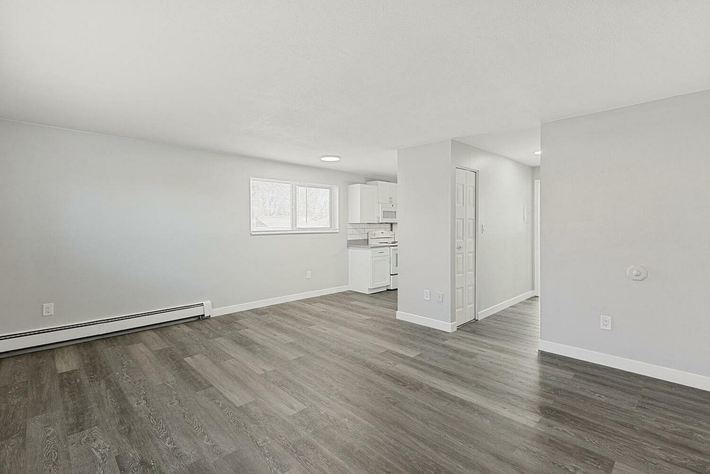 A room with a wooden floor and white walls.