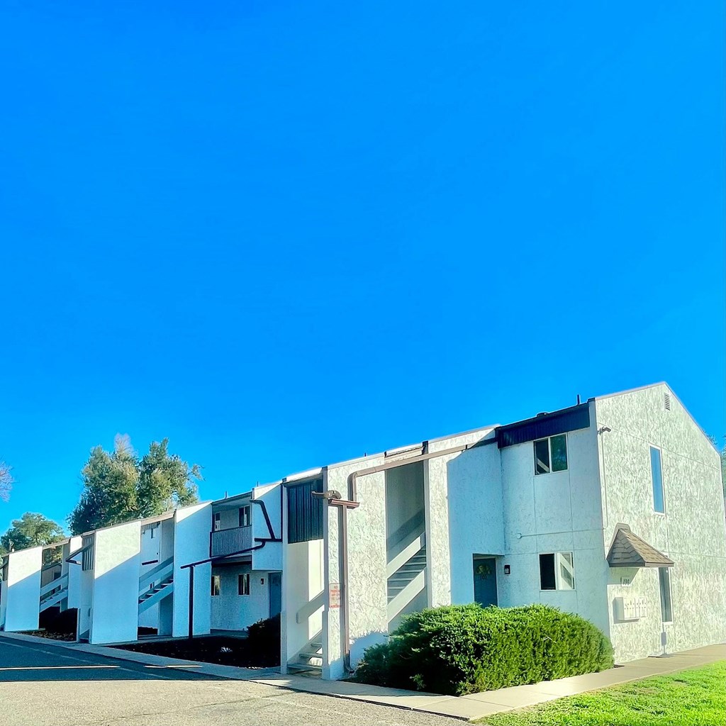 A white building with a blue sky in the background.