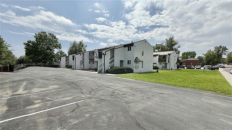 A parking lot with a building in the background.
