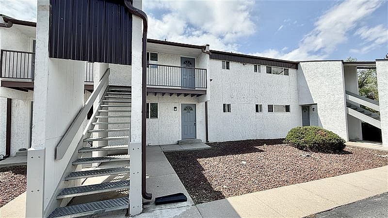 A modern building with a staircase leading to the entrance.