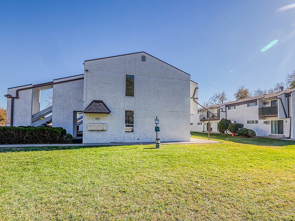 A white building with a black roof and a sign that reads "1289".
