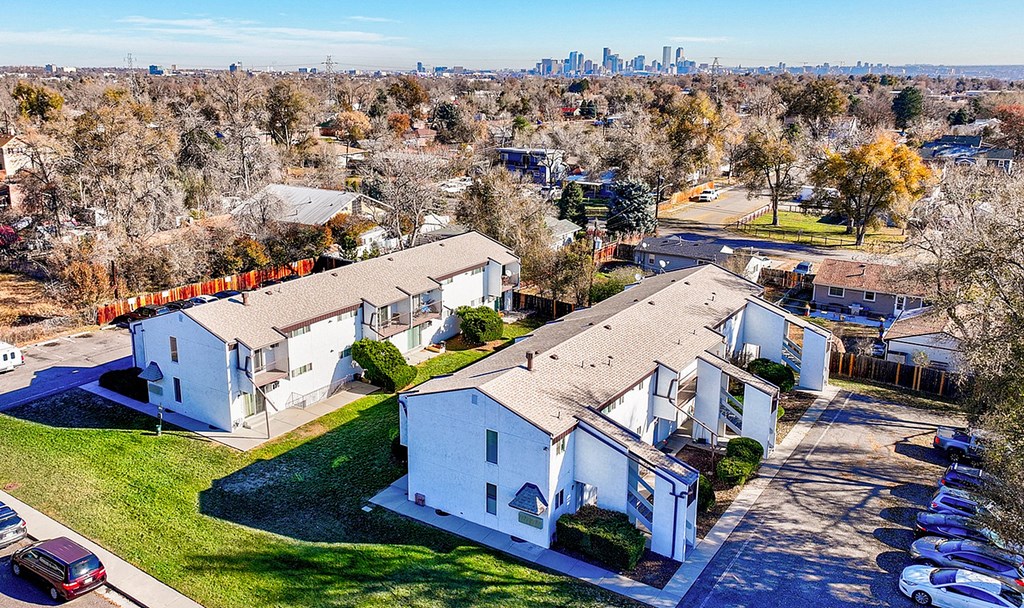 A suburban neighborhood with houses and cars parked in the driveways.