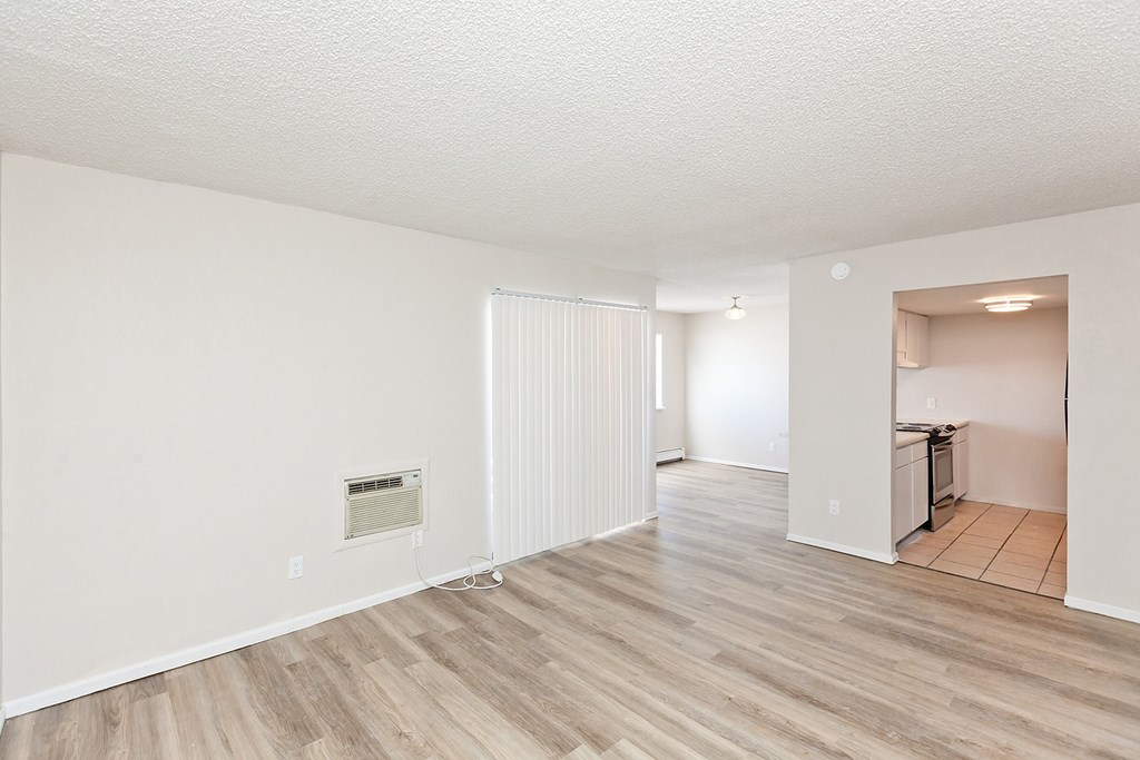 A room with a white ceiling and wooden flooring.