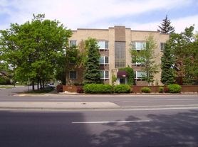 A building with a red brick border in front of it.