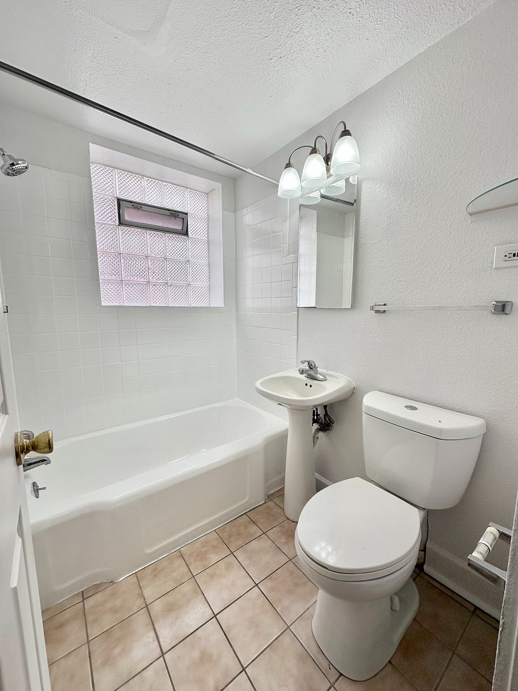 A white toilet sits next to a sink in a small bathroom.