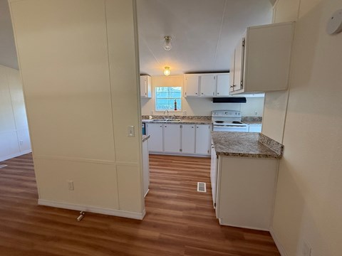 A kitchen area with a counter and cabinets.