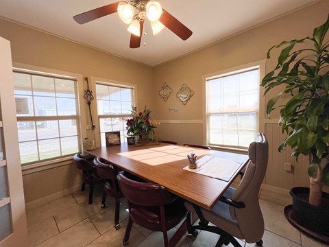 A dining room with a wooden table and chairs.