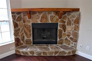 A stone fireplace with a wood mantle.
