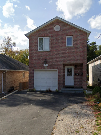 A red brick house with a white garage door.