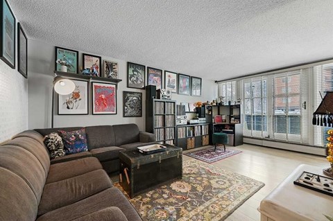 A living room with a brown couch and a coffee table.