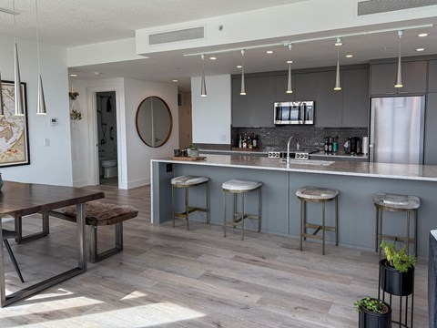 A kitchen with a bar area and a dining table.