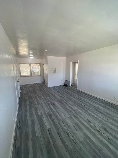 A room with a grey floor and white walls.