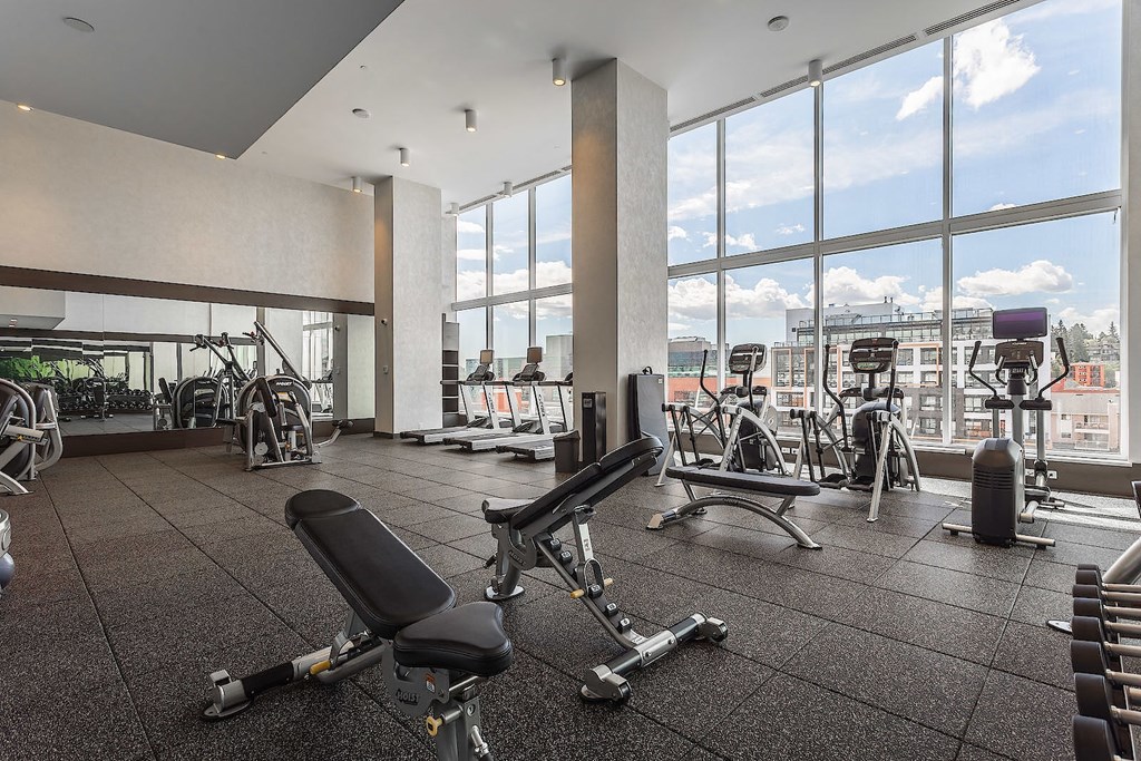 A gym with a view of the city outside the windows.