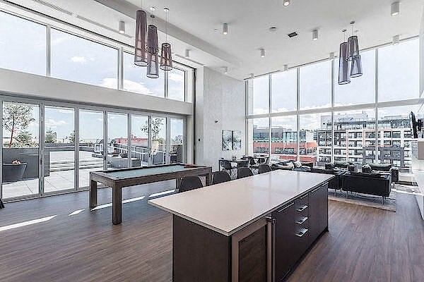 A modern office space with a long table and chairs.