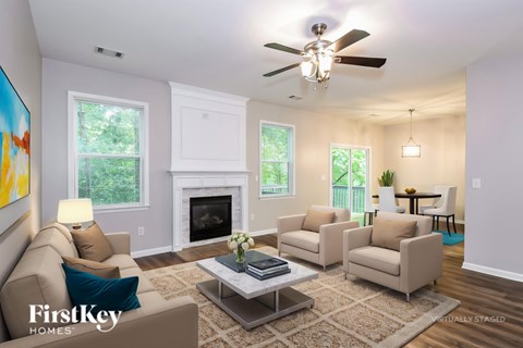 A living room with a fireplace and a painting on the wall.