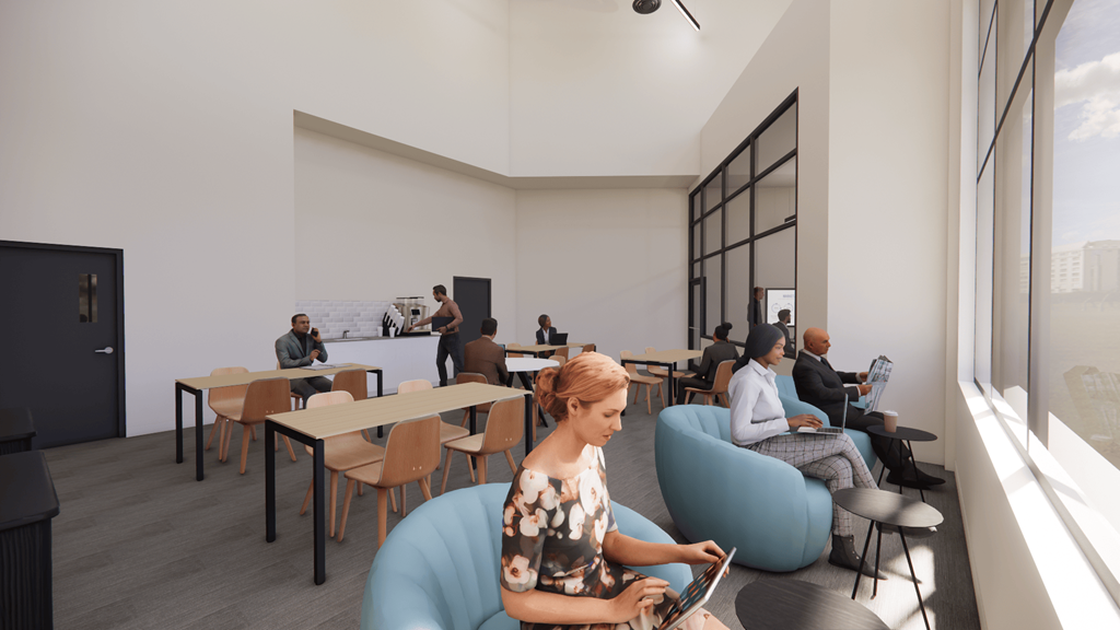 A group of people are sitting in a modern room with a woman in the foreground using a laptop.