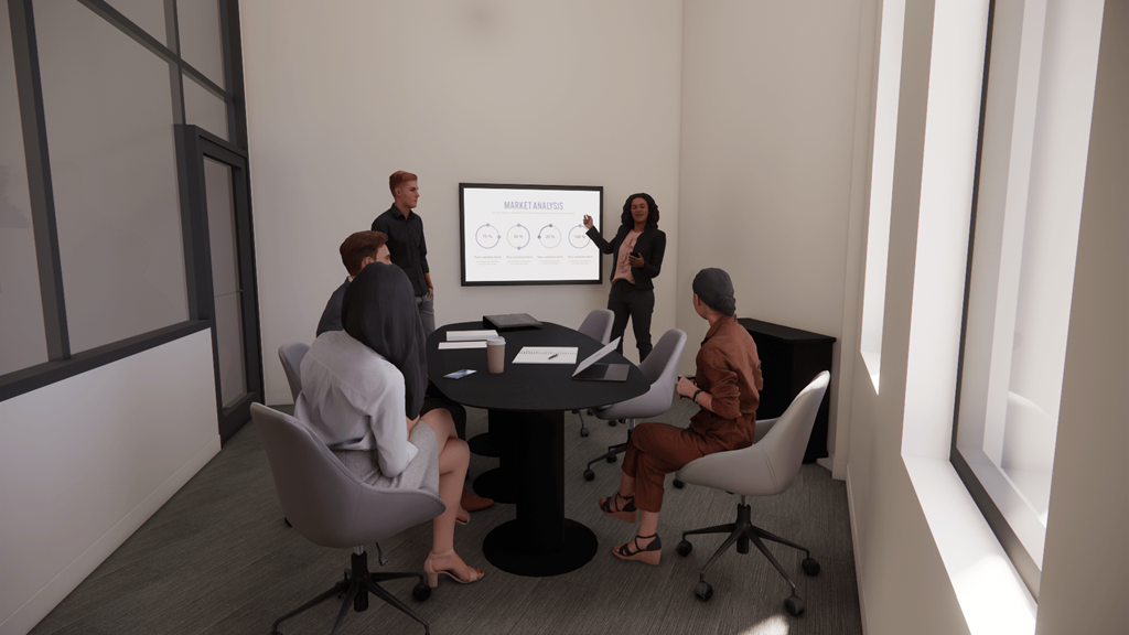 Three people are sitting around a table in a meeting room.