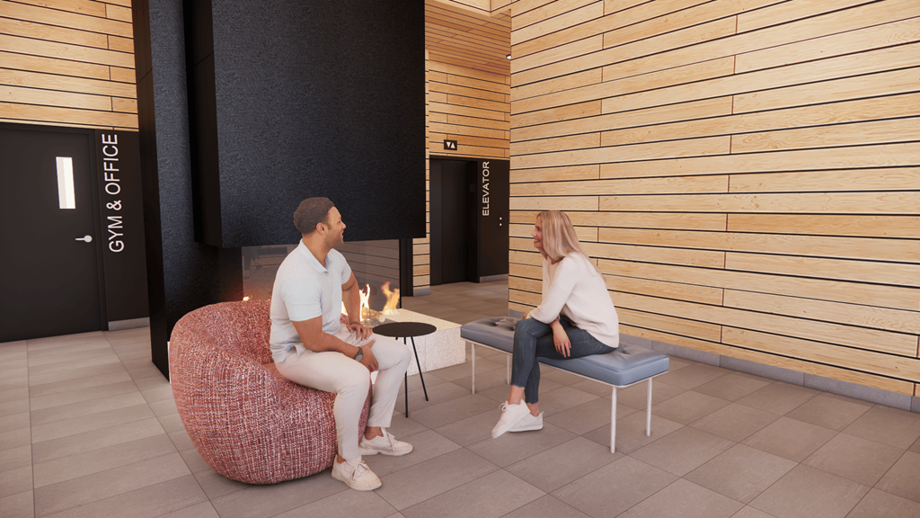 Two people sitting in a room with a sign that says "GYM & OFFICE".