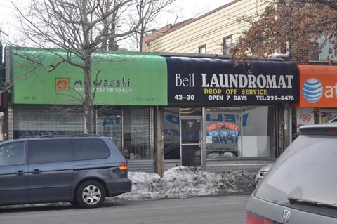 A laundromat and an Arabic restaurant share a street corner.