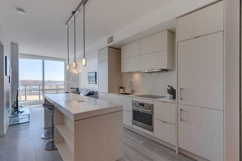 A modern kitchen with a large island and stainless steel appliances.