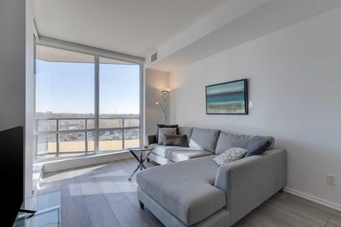 A living room with a grey couch and a television.