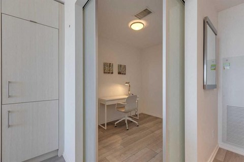 A white room with a desk and a chair.